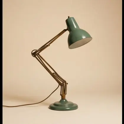 Brass and sage enamel articulated desk lamp, rotated 225 degrees.